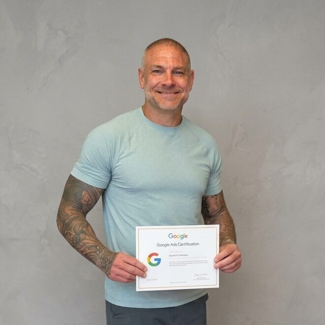 Ryan Russell, founder of Red Rhino Digital, holding his Google Ads certification